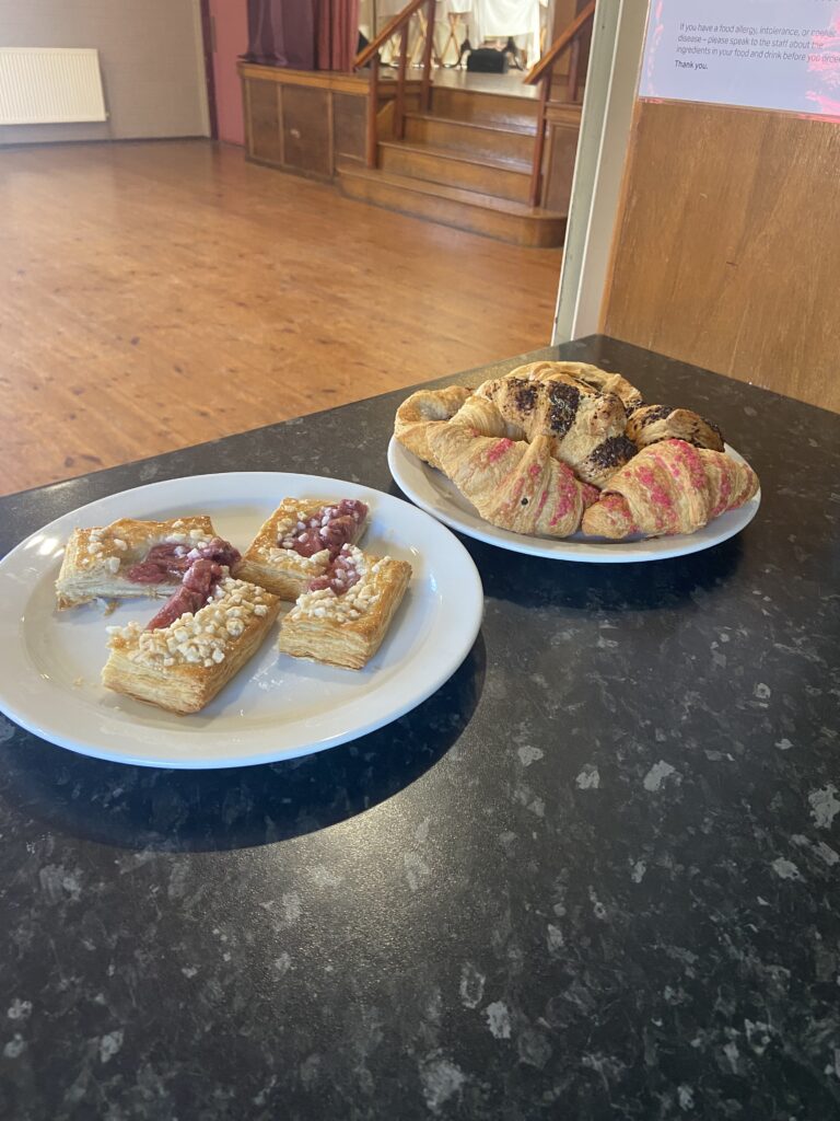 Plates of breakfast pastries on a black kitchen counter