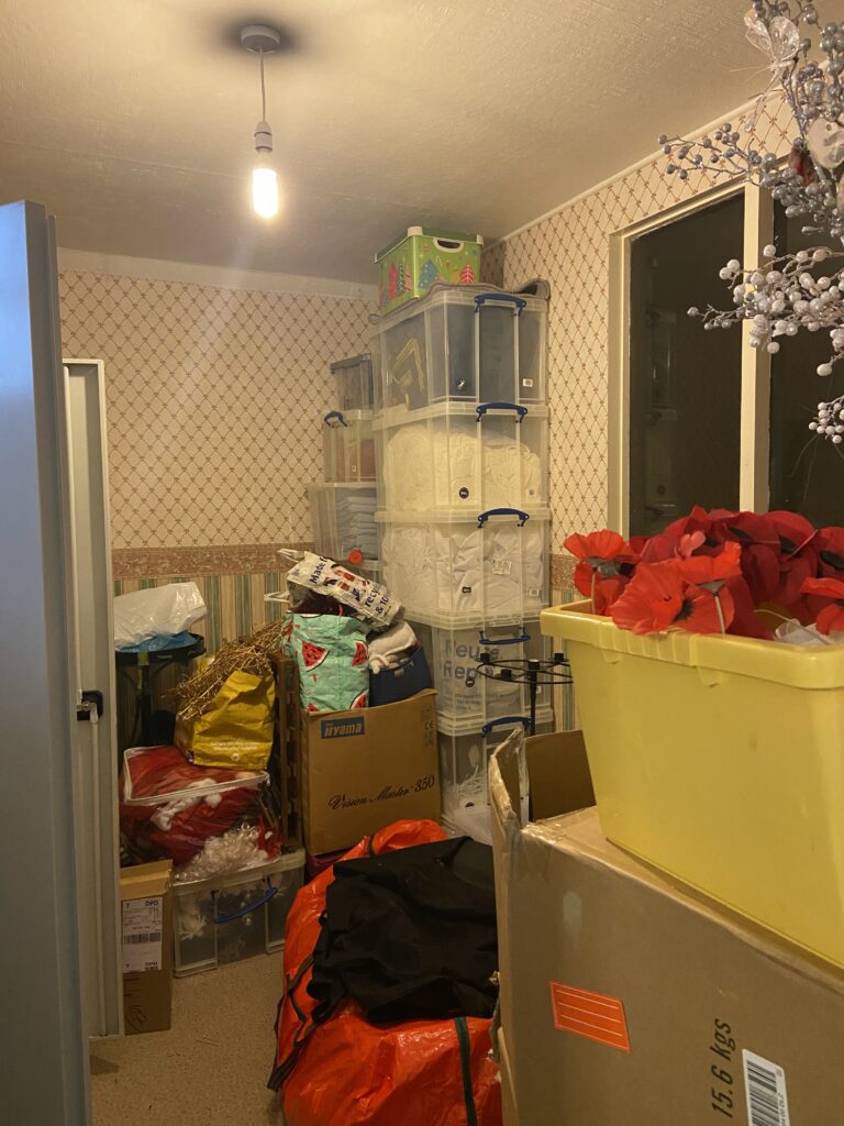 A small room stacked floor to ceiling with boxes and metal cupboards